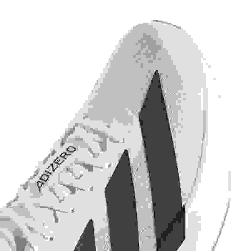 A white and black athletic shoe with a textured upper and laces against a plain white background.