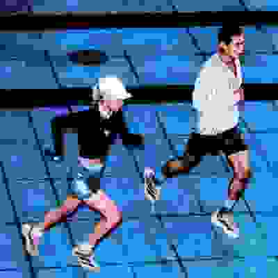 close up of legs of people in black shoes and pink socks