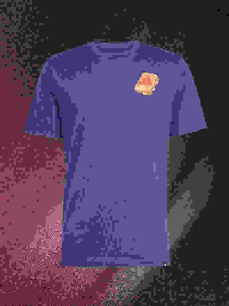 A blue t-shirt with a red and yellow shell-shaped logo is displayed against a dark, textured background.