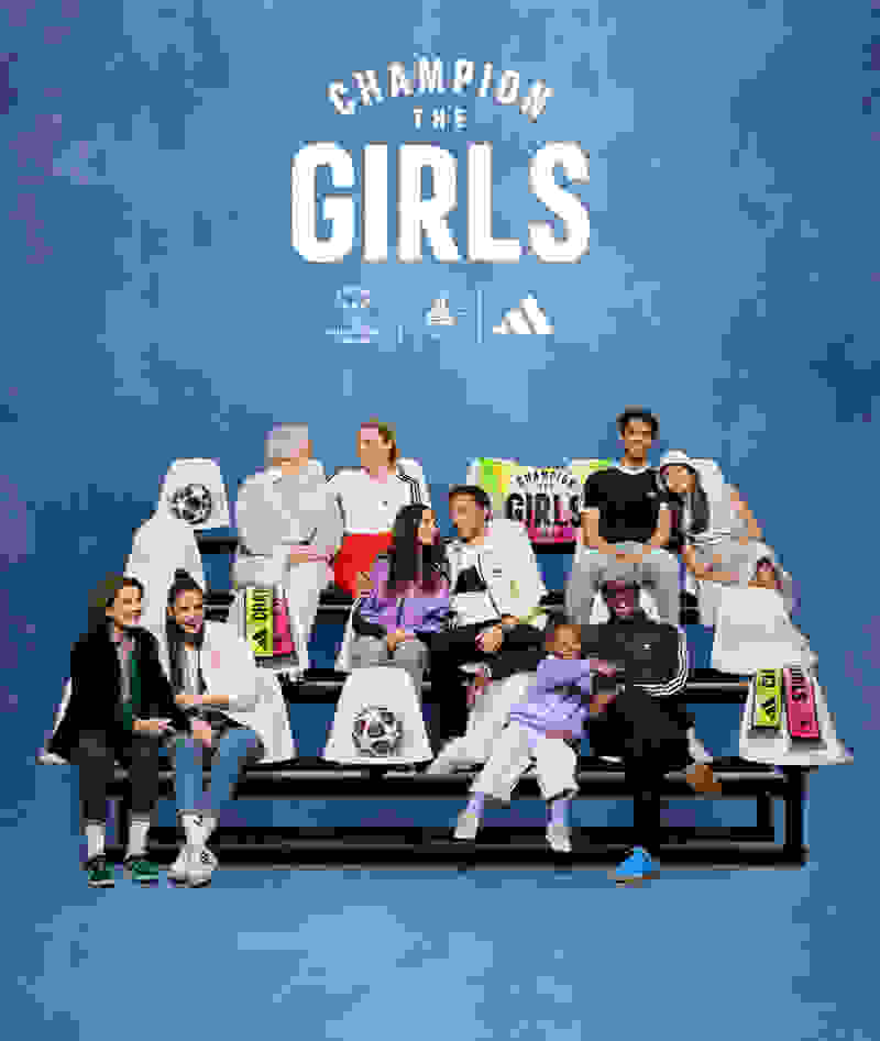 Football players sitting togther with their daughters and parents