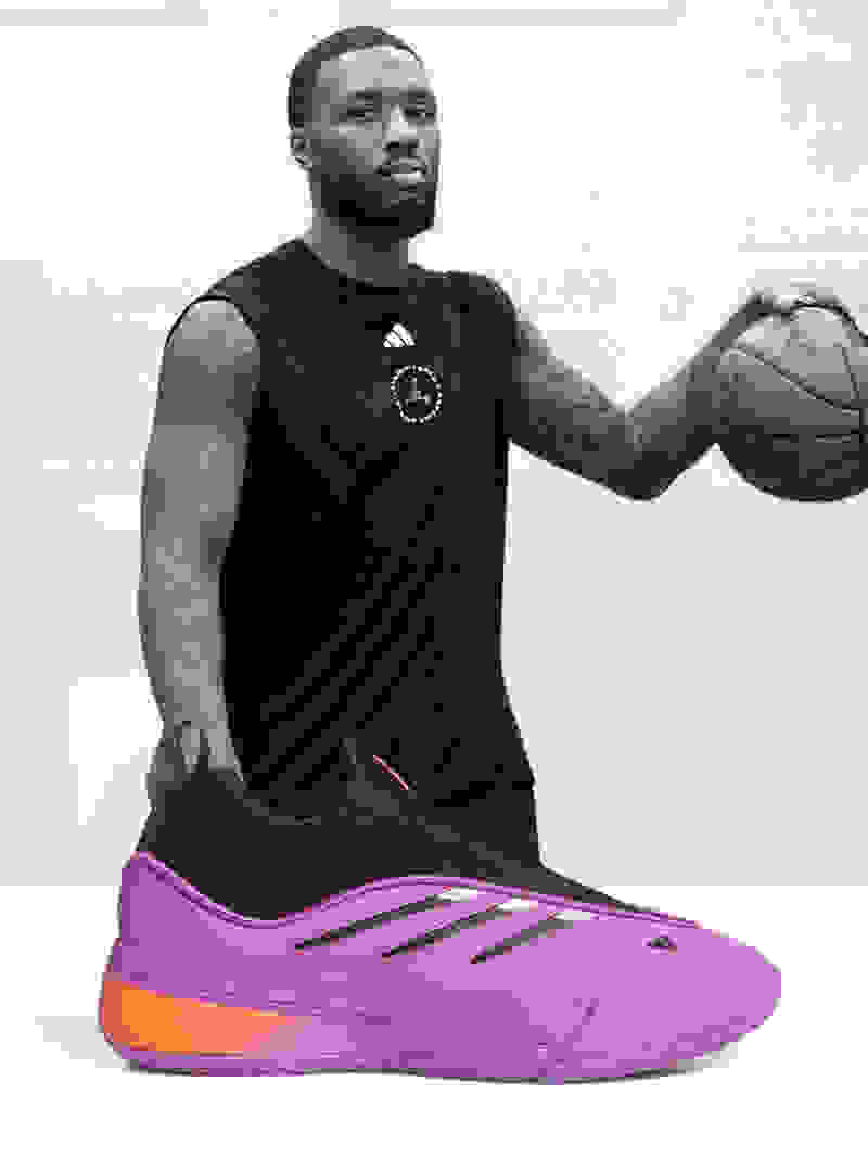 Damian Lillard holding basketball, with purple and black Dame 9 basketball shoe superimposed