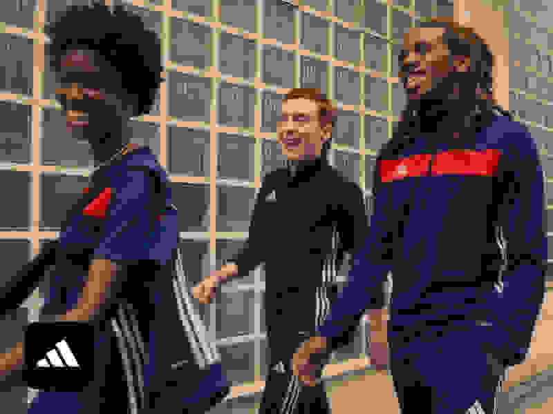 Three friends in adidas sportswear walking together.