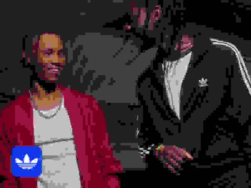 Two adiClub members talking and smiling at each other. 