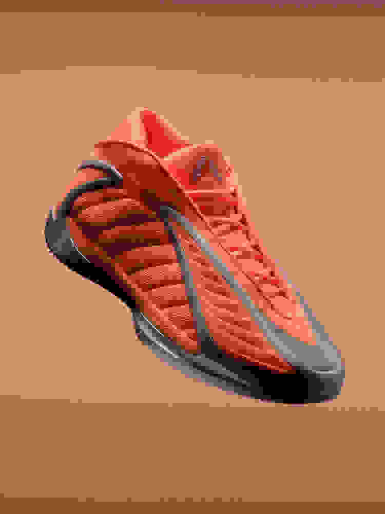 A vibrant, orange-red athletic shoe with a sleek, modern design stands against a plain, peach-colored background.