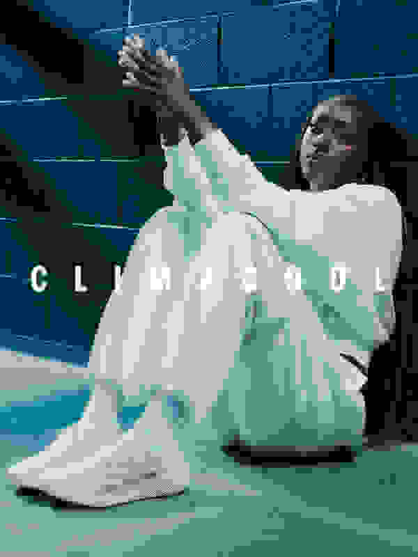 Kahleah Cooper wears a white outfit and sits on the floor against a dark wall, wearing beige adidas Climacool laced trainers. The word "CLIMACOOL" is overlaid in white text.