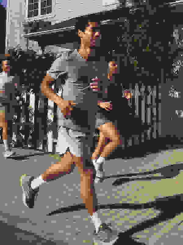 Image of two adults running outdoors in Supernova Rise 2, wearing adidas apparel.