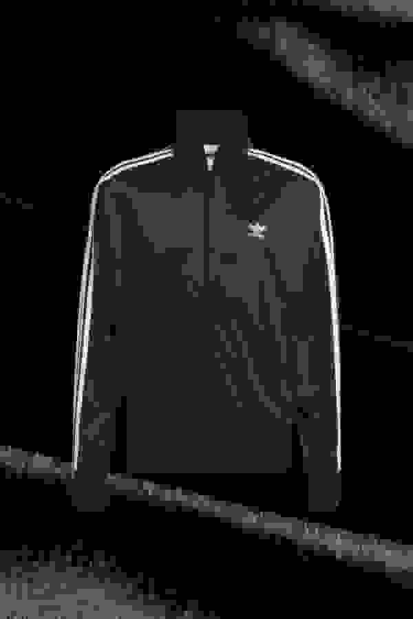Front view of black Firebird adidas jacket.