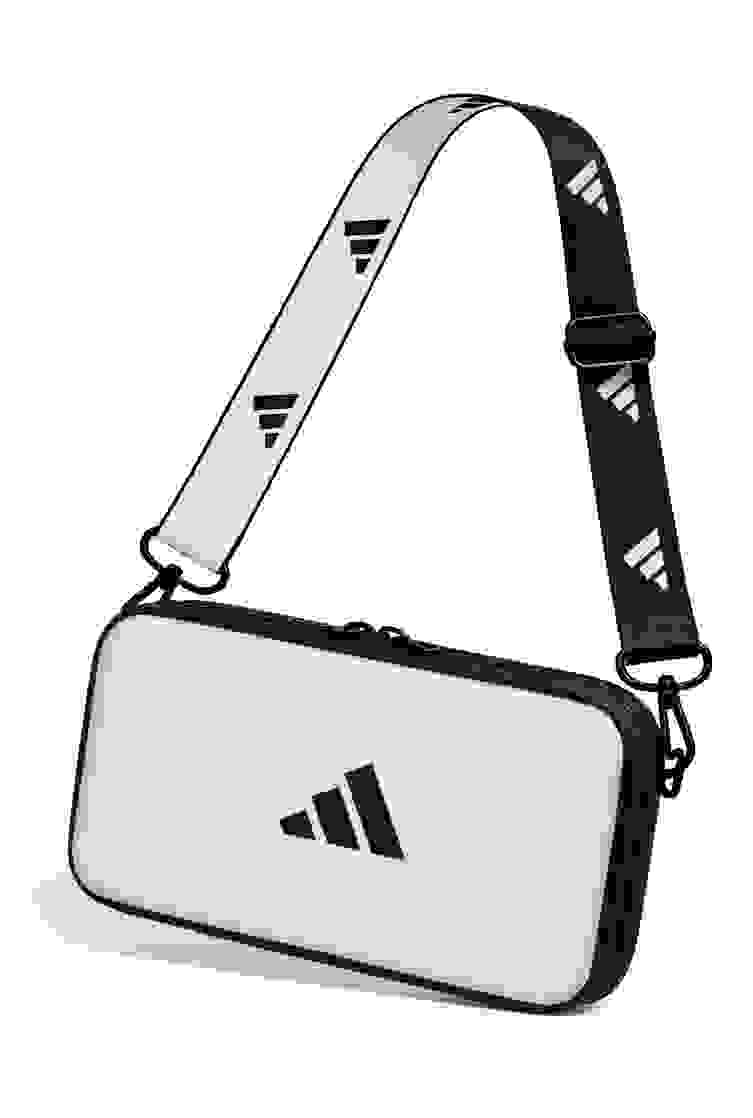 A white rectangular bag with the Adidas logo, featuring a black strap with the Adidas brand name printed on it.