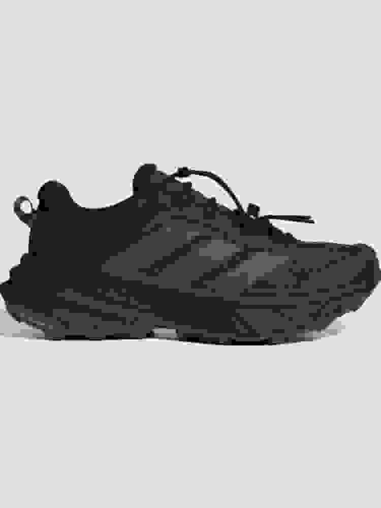 A pair of black and gray athletic shoes with a rugged, outdoor-oriented design, set against a plain white background.