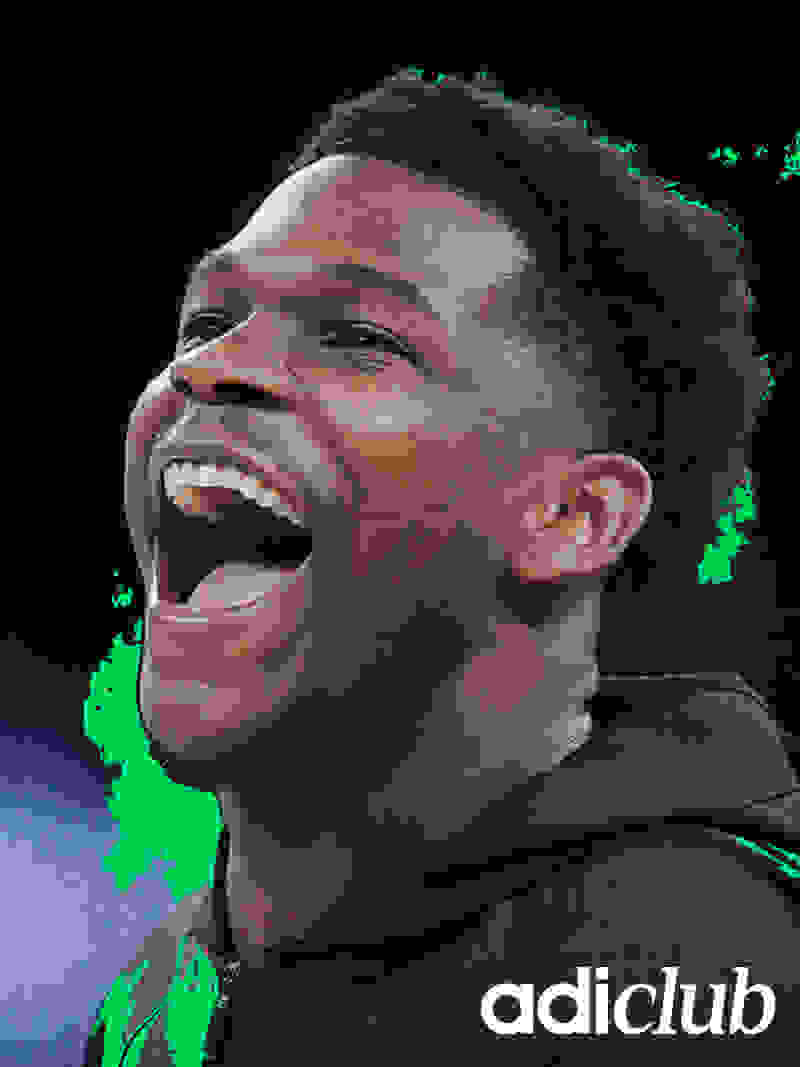 A smiling young man with a black hoodie against a dark background with green splatters.