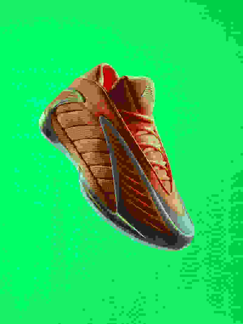 A vibrant orange and brown athletic shoe with distinctive design elements is prominently displayed against a vivid green background.