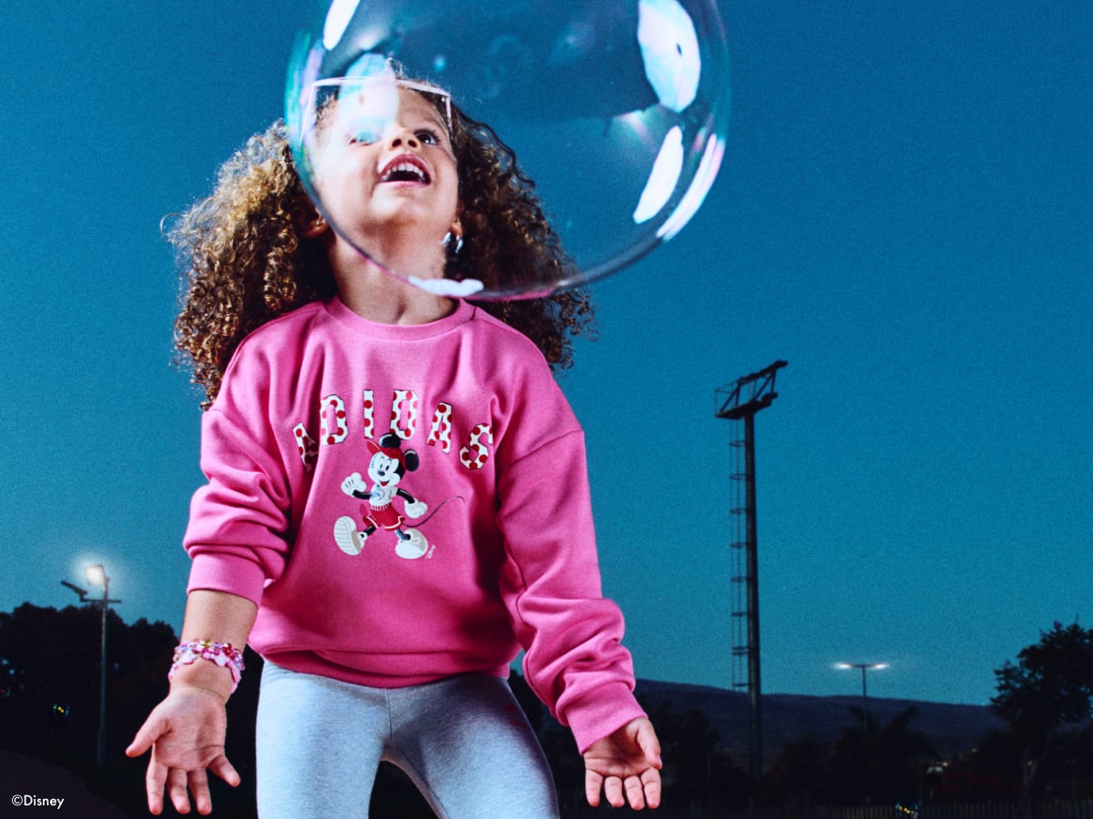 One child playing with bubbles, wearing the adidas | Minnie collection