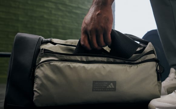 Close up shot of someone holding an adidas strength training bag.