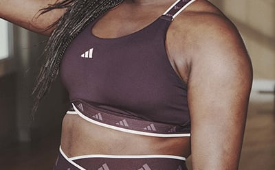 Image of a model’s chest wearing a plum medium support sports bra