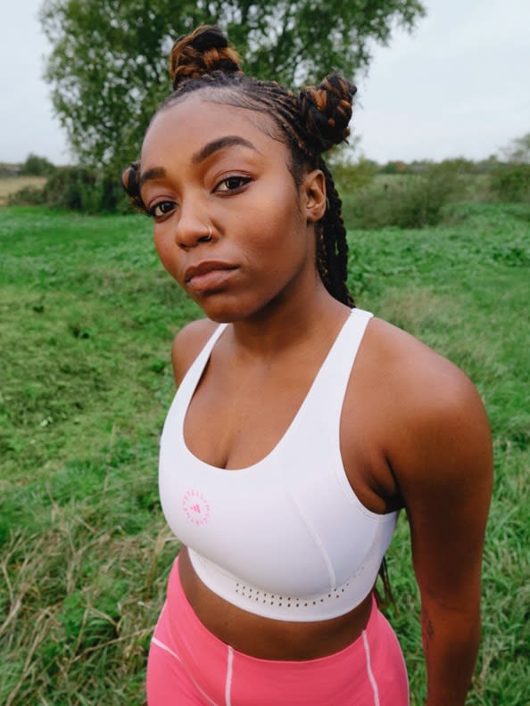 A collection of 3 images featuring the latest Workout Wardrobe drop from adidas by Stella McCartney.1. Leila Davis looks to camera wearing a white bra and pink leggings. 2. Nami Nagakura stands in all-yellow. 3. Leila Davis smiles wearing an all-grey look with a neon-accented bum bag.