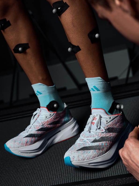 Man runs on treadmill wearing an oxygen mask and a variety of sensors and the Adidas Prime X 2 Strung