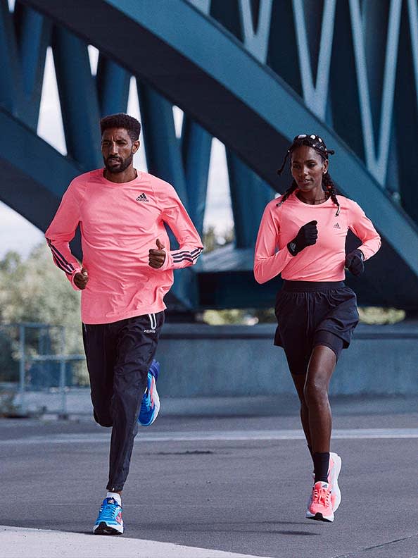 Man and woman running together with the adidas Adistar running shoe