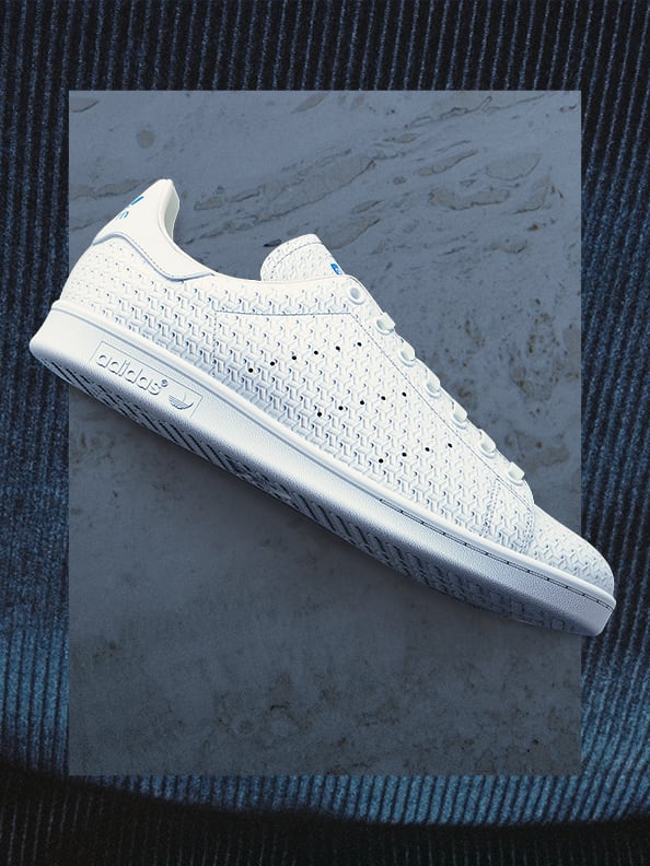 A white Stan Smith sneaker against a neutral background.