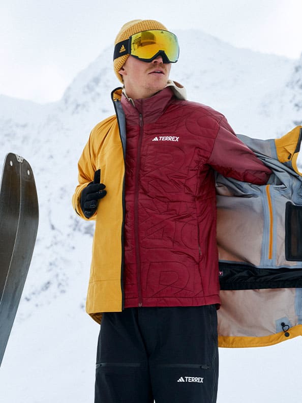A person wearing a yellow jacket and goggles