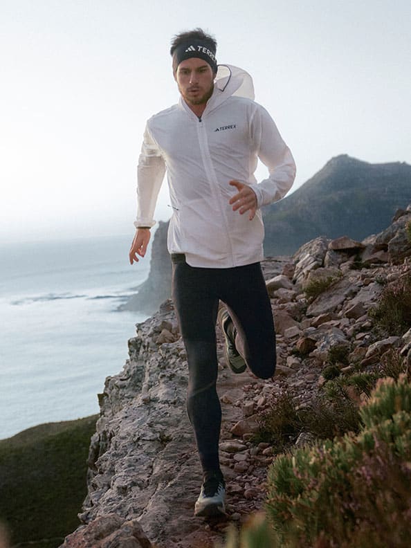 A person running on a rocky cliff