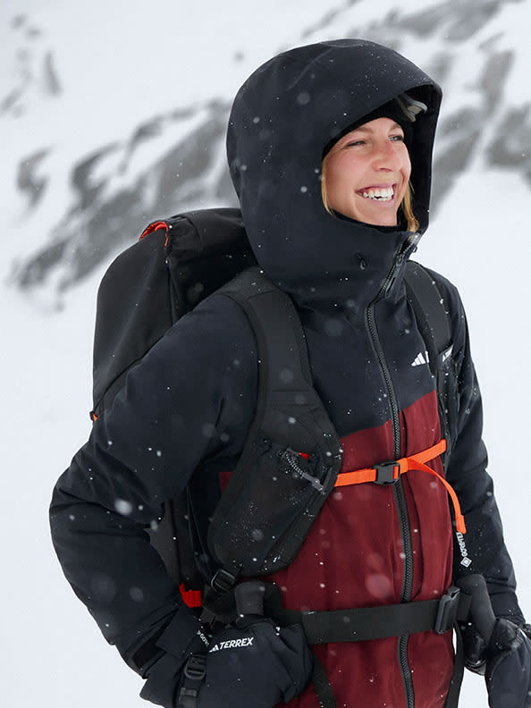 A person wearing a backpack and a black jacket
