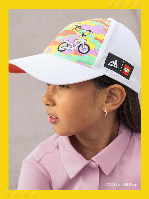 A little girl wearing adidas LEGO® cap and dress.