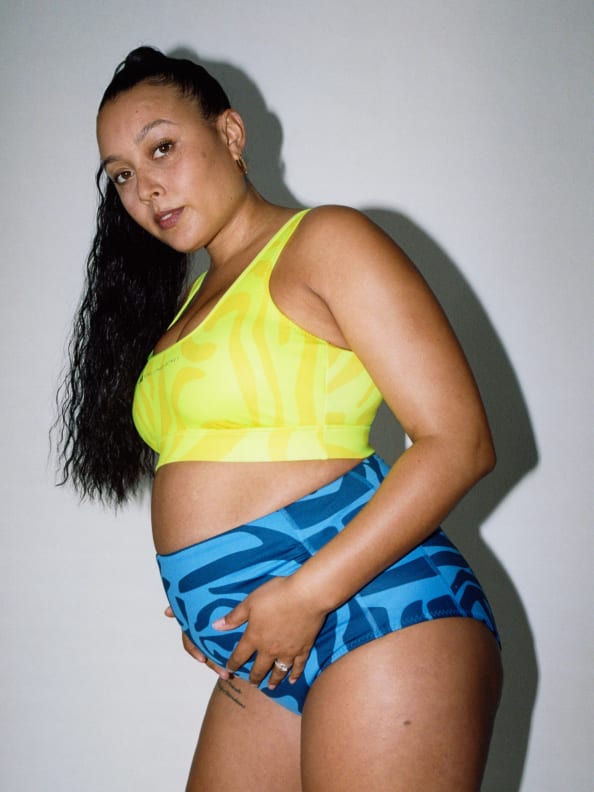 Izzy stands wearing the Truenature Maternity Bikini top and bottom from the new SS23 adidas by Stella McCartney.