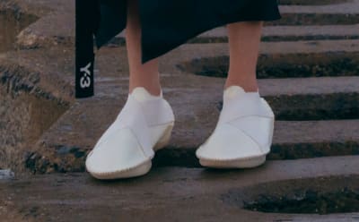 Woman standing in white Y-3 footwear
