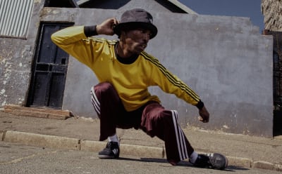 A man is photographed wearing adidas Originals.