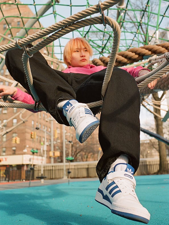 Models wearing both the Forum Low and Forum Mid in a variety of styles.