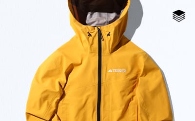 A yellow Adidas Terrex jacket with a hood
