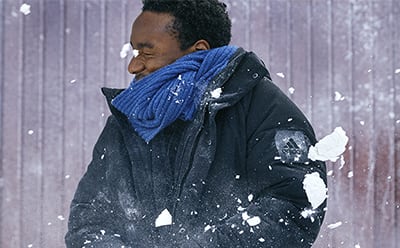 Man getting hit by a snowball.