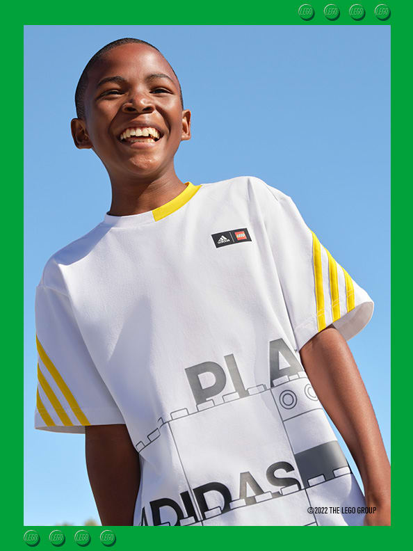 Boy smiling wearing a white adidas LEGO t-shirt