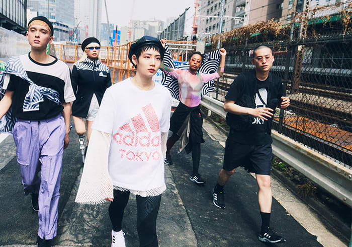 A group of young Tokyoites wearing items from HIROKO TAKAHASHI COLLECTION are walking along the street in Tokyo. Their energy is connected with each other and heading towards the same direction.