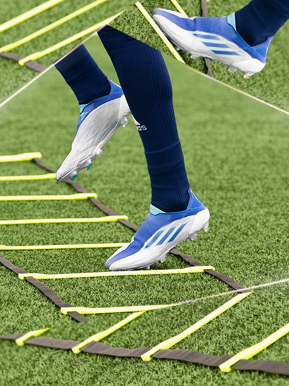 Image of a speed ladder, player with blue socks does speed exercises with the X P0.