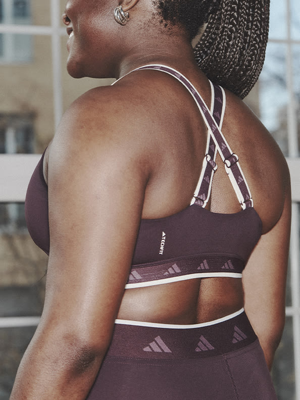 Image of the back of a model wearing plum bra and tights co-ord