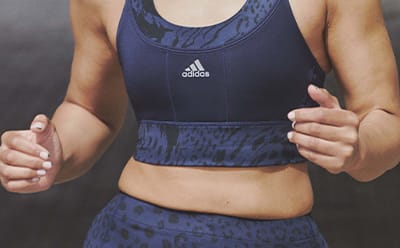 Image of a model’s chest wearing a navy high support sports bra
