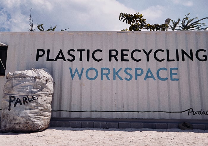 There is a big bag with a Parley logo that is filled with plastic waste