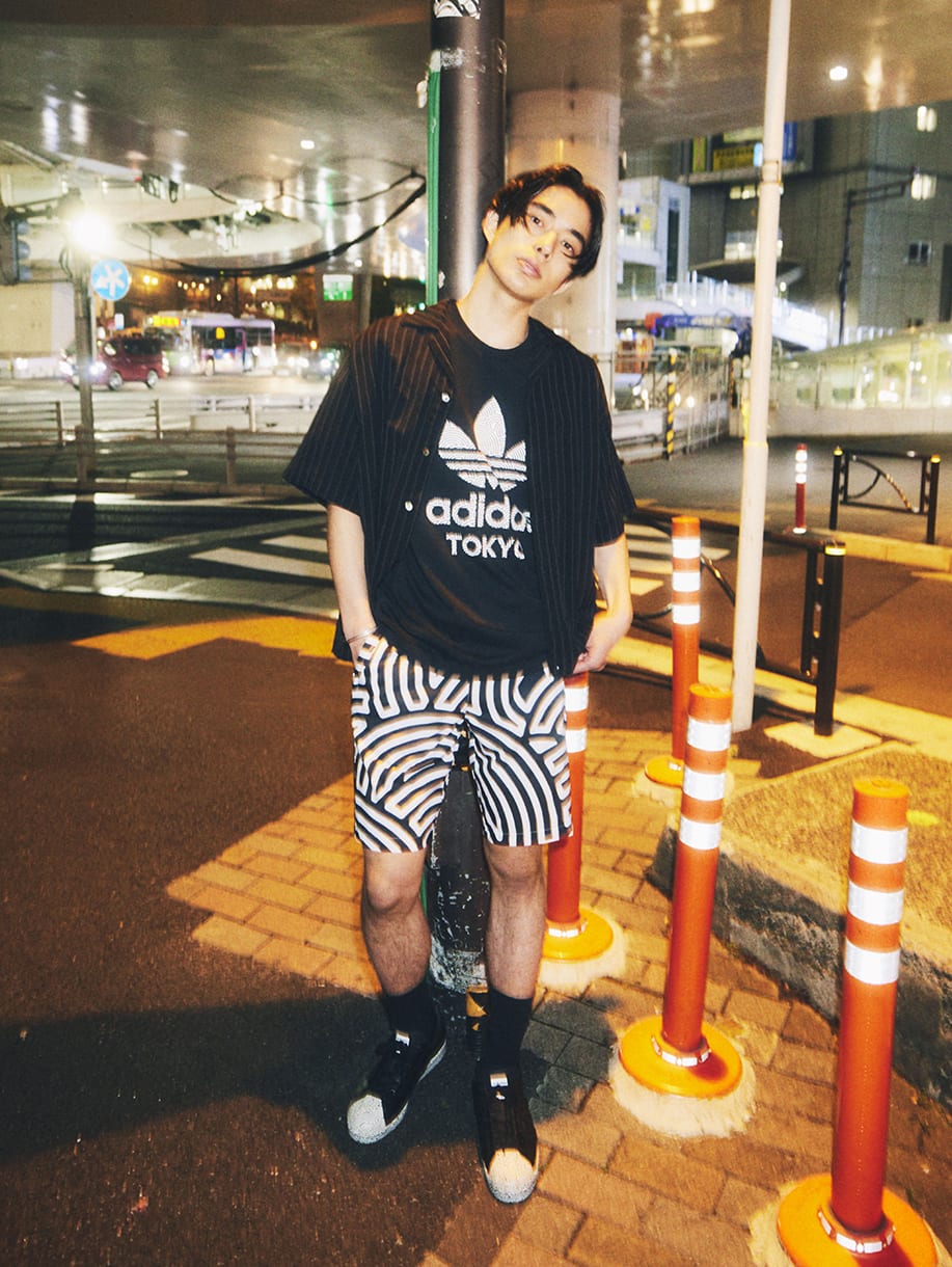 A young man wearing items from HIROKO TAKAHASHI COLLECTION.