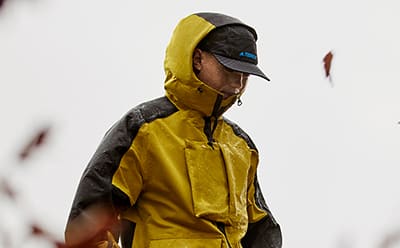 Man in waterproof gear standing in the rain.