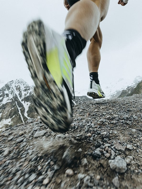 Athlete wearing the Agravic Ultra running up moutain trails