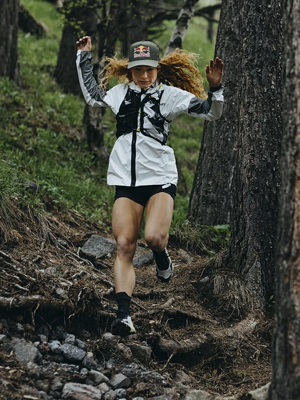 Athlete Ekaterina wearing the Agravic Ultra running down rocky mountain trails