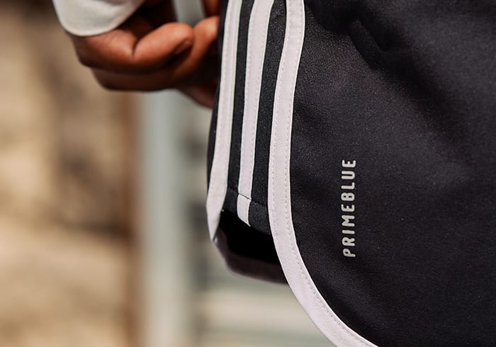 A man is wearing Primeblue shorts