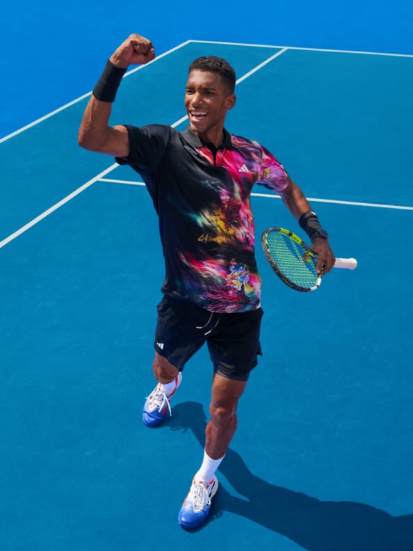 Male tennis player holding a fist in victory