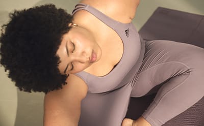 Image of a model stretching wearing a lavender bra and tights co-ord