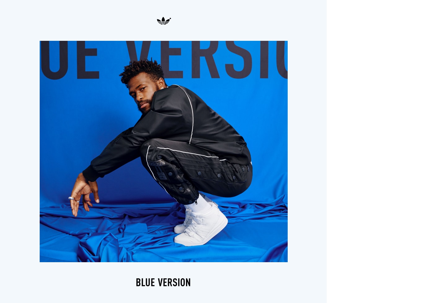 An image of Duckwrth squatting wearing a Blue Version Seefeld track suit in black.