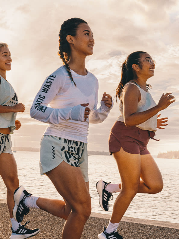 Visual of women running by the ocean