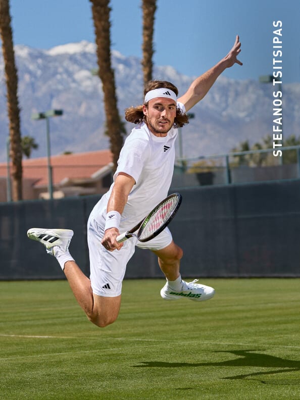 Stefanos Tsitsipas wearing the new adidas tennis english tournement outfit, playing tennis on the grass court