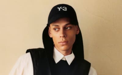 A model is pictured wearing a Y-3 cap.