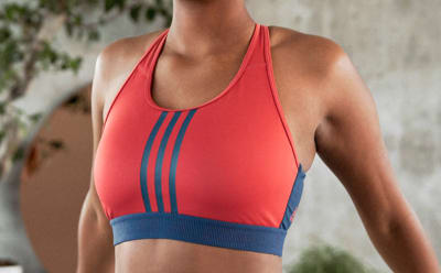 A close-up of a woman's chest, she is wearing a red and blue bra.